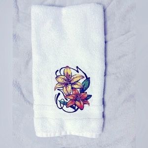 Floral embroidered hand towel featuring a pair of lilies.